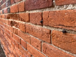 The graffitied wall of the Wicklewood workhouse yard, a subversive memorial  and perhaps an example of 'disorderly' behaviour?